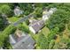 Aerial view of the house showing the backyard, deck, mature trees, and surrounding neighborhood at 10043 Elsenham Ln, Charlotte, NC 28269