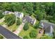 Aerial view of the house featuring mature trees, long driveway and a well-kept lawn in quiet neighborhood at 10043 Elsenham Ln, Charlotte, NC 28269