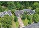 Aerial view of the house with lush trees, and a long driveway, in a lovely neighborhood at 10043 Elsenham Ln, Charlotte, NC 28269