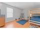 Well-lit bedroom featuring a bunk bed, shelves, dresser, and neutral color palette at 10043 Elsenham Ln, Charlotte, NC 28269