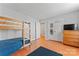 Bedroom featuring a wooden bunk bed, dresser, and blue accents, all illuminated by natural light at 10043 Elsenham Ln, Charlotte, NC 28269