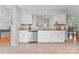 Bright kitchen with white cabinets, granite countertops, stainless steel appliances, and a view to dining area at 10043 Elsenham Ln, Charlotte, NC 28269