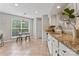 Eat in kitchen with granite countertops, white cabinets, and a view from the sink at 10043 Elsenham Ln, Charlotte, NC 28269