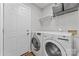 Functional laundry room featuring modern washer, dryer, shelving, and convenient access to the outside at 10043 Elsenham Ln, Charlotte, NC 28269