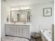 Bathroom featuring a double vanity sink, garden tub, and modern fixtures at 1008 Millbridge Pkwy, Waxhaw, NC 28173