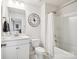 Bright bathroom featuring a large mirror, a tub and shower combo with white shower curtain at 1008 Millbridge Pkwy, Waxhaw, NC 28173