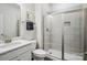 Modern bathroom featuring a glass-enclosed shower, vanity, and neutral color palette at 1008 Millbridge Pkwy, Waxhaw, NC 28173