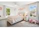 Bright bedroom with neutral carpet, lots of natural light, and a bed with soft pink details at 1008 Millbridge Pkwy, Waxhaw, NC 28173