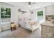 Bright bedroom with neutral carpet, lots of natural light, and a bed with colorful details at 1008 Millbridge Pkwy, Waxhaw, NC 28173