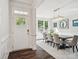 Elegant dining room with hardwood floors, stylish chandelier, and abundant natural light at 1008 Millbridge Pkwy, Waxhaw, NC 28173