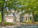 Charming home featuring a stone facade, well-manicured lawn and a two-car garage at 1008 Millbridge Pkwy, Waxhaw, NC 28173