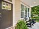 Inviting front porch featuring comfortable seating, a charming fern, and a welcoming entrance at 1008 Millbridge Pkwy, Waxhaw, NC 28173
