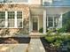 Inviting front porch featuring stone accents, beautiful landscaping, and welcoming front door at 1008 Millbridge Pkwy, Waxhaw, NC 28173