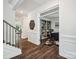 Hallway with hardwood floors and decorative moldings that leads to home office space at 1008 Millbridge Pkwy, Waxhaw, NC 28173