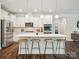 Kitchen with large island and bar stool seating, modern appliances and cabinetry at 1008 Millbridge Pkwy, Waxhaw, NC 28173
