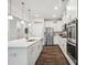 Well-equipped kitchen with stainless steel appliances, sleek white cabinetry and an island at 1008 Millbridge Pkwy, Waxhaw, NC 28173