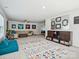 Open living area with sectional seating, TV, an area rug, and natural light at 1008 Millbridge Pkwy, Waxhaw, NC 28173