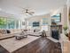 Comfortable living room with a stone fireplace, large sectional sofa, and natural light at 1008 Millbridge Pkwy, Waxhaw, NC 28173