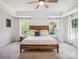 Bright main bedroom featuring a wooden bed frame, a ceiling fan, and natural light at 1008 Millbridge Pkwy, Waxhaw, NC 28173