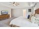 Bright main bedroom featuring a ceiling fan, soft carpet, and large dresser at 1008 Millbridge Pkwy, Waxhaw, NC 28173