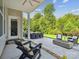 Back patio with dining and seating area that includes an outdoor fireplace and a lush backyard at 1008 Millbridge Pkwy, Waxhaw, NC 28173