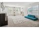 Bright and spacious play room with a window and comfortable blue furniture at 1008 Millbridge Pkwy, Waxhaw, NC 28173
