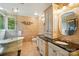 Elegant bathroom with double vanity, granite countertops, soaking tub, and decorative tile work at 1042 Heather Glen Dr, Matthews, NC 28104