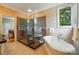 Bathroom featuring a glass-enclosed shower, soaking tub, and beautiful tile work at 1042 Heather Glen Dr, Matthews, NC 28104