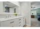 Bathroom featuring double sinks, a large mirror, and access to the shower at 1042 Heather Glen Dr, Matthews, NC 28104