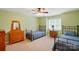 Inviting bedroom with bright green walls, ceiling fan, and natural light from the window at 1042 Heather Glen Dr, Matthews, NC 28104