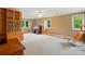 Large bonus room with built-in shelving, desk, and lots of natural light at 1042 Heather Glen Dr, Matthews, NC 28104