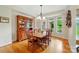 Dining room with wooden table, cabinet, and bay windows offering views of the well-maintained yard at 1042 Heather Glen Dr, Matthews, NC 28104