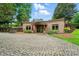 Attractive single story home features a large driveway, lovely landscaping, and a covered entrance at 1042 Heather Glen Dr, Matthews, NC 28104