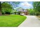 Beautiful home with a well manicured lawn and long driveway at 1042 Heather Glen Dr, Matthews, NC 28104