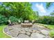 Outdoor fire pit area with stone patio and comfortable seating, perfect for relaxing outside at 1042 Heather Glen Dr, Matthews, NC 28104