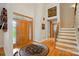 Grand foyer with hardwood floors, a decorative rug, and a staircase with iron railing at 1042 Heather Glen Dr, Matthews, NC 28104