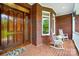 Inviting front porch with brick flooring, rocking chairs, and decorative accents at 1042 Heather Glen Dr, Matthews, NC 28104