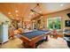 Spacious game room featuring high wood-clad ceilings, a billiard table and ample natural light at 1042 Heather Glen Dr, Matthews, NC 28104