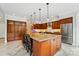 Modern kitchen boasts a large island with seating, granite countertops and stainless steel appliances at 1042 Heather Glen Dr, Matthews, NC 28104