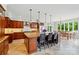 Spacious kitchen with granite counters, large island and stainless steel appliances, dining area with natural lighting at 1042 Heather Glen Dr, Matthews, NC 28104