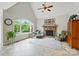 Bright living room with fireplace, cathedral ceilings, large arched window, and tile floors at 1042 Heather Glen Dr, Matthews, NC 28104