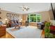 Cozy living room featuring hardwood floors, a large arch window, and comfortable seating at 1042 Heather Glen Dr, Matthews, NC 28104