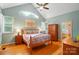 Bedroom with a vaulted ceiling, a large window, hardwood floors, and an ensuite bathroom at 1042 Heather Glen Dr, Matthews, NC 28104
