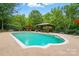 Serene pool area featuring a gazebo and beautifully landscaped backyard at 1042 Heather Glen Dr, Matthews, NC 28104