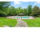 Inviting pool area with lush landscaping, gazebo, and ample seating at 1042 Heather Glen Dr, Matthews, NC 28104