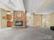 Finished basement with a cozy stone fireplace and neutral carpeting at 106 Boyter Ct, Cramerton, NC 28032