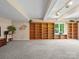 Large open basement area with built-in bookshelves and ample lighting at 106 Boyter Ct, Cramerton, NC 28032