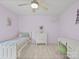 Charming bedroom with lilac walls, ceiling fan, and white furnishings, offering a peaceful and stylish retreat at 106 Boyter Ct, Cramerton, NC 28032