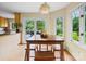 Bright breakfast nook with a wooden table, bench seating, and access to the deck at 106 Boyter Ct, Cramerton, NC 28032