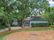 Charming home with mature trees, attractive landscaping, and a well-maintained lawn at 106 Boyter Ct, Cramerton, NC 28032